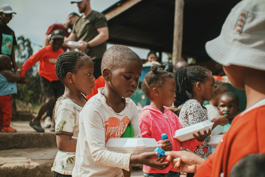 a group of young children standing next to each other